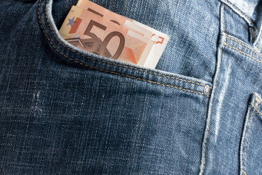 euro money in the front pocket of jeans