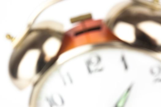 Close up of an alarm clock on a white background - blurred