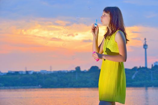 girl with soap bubbles in nature