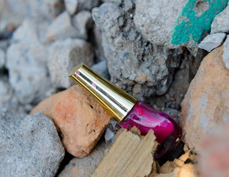 KATHMANDU, NEPAL - MAY 22, 2015: A nail polish pot lies among the rubble after two major earthquakes hit Nepal on April 25 and May 12, 2015.