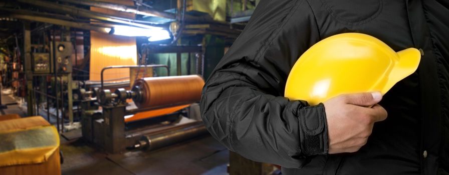 Worker with safety helmet at industrial factory