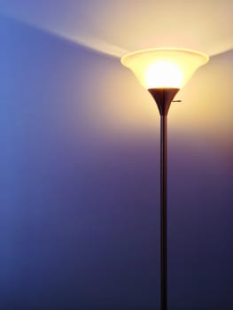 Bright lamp with contemporary design, on purple background.