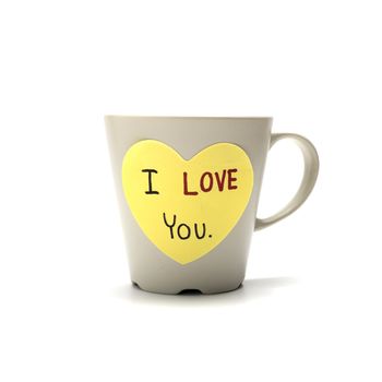 I love you write on heart paper card with coffee mug isolated on white background