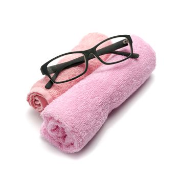eyeglasses on towel isolated on white background