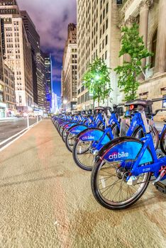 NEW YORK CITY - JUNE 8, 2013: New blue CitiBikes lined up in Manhattan downtown. Citi Bike is the largest bike sharing program in the United States