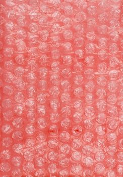 Air-bubble wrap texture on red background, close-up view