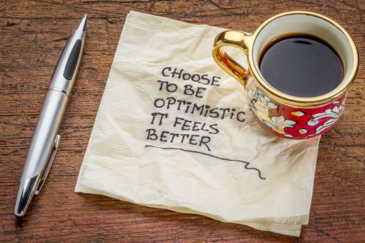 choose to be optimistic, it feels better - motivational handwriting on a  napkin with a cup of coffee