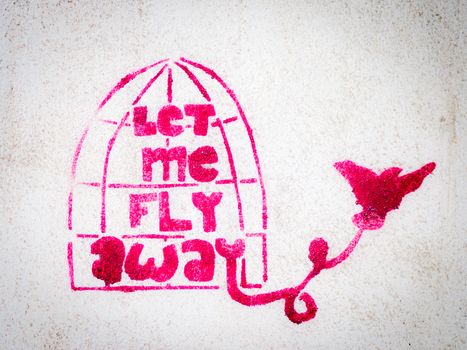 Pink stencil graffiti with bird leaving a cage, freedom expression