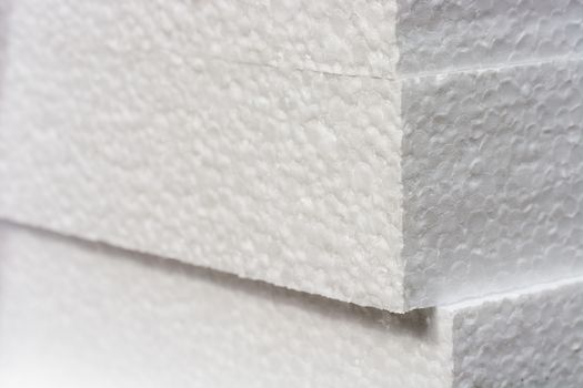 Polystyrene insulation boards background with copyspace and accented sharpness on edges