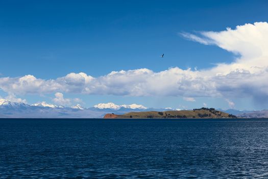 Isla de la Luna (Island of the Moon) in Lake Titicaca, Bolivia with the mountain range of the Andes in the back photographed from the popular tourist destination of Isla del Sol (Island of the Sun)