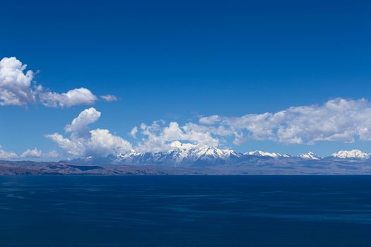 The mounain range of the Andes along the shore of Lake Titicaca in Bolivia viewed from the popular tourist destination of Isla del Sol (Island of the Sun)