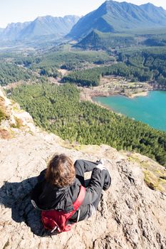 Woman enjoying rewarding view of  Seattle Washington Rattlesnake Ledge Trail after 40 minute trekking