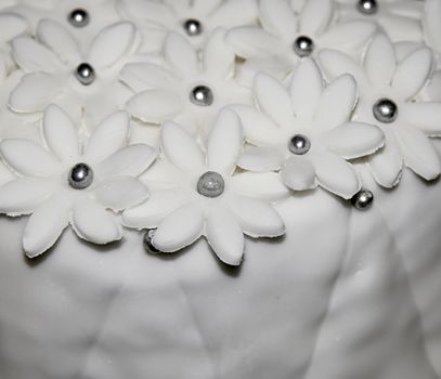 background White sugar flowers on the cake