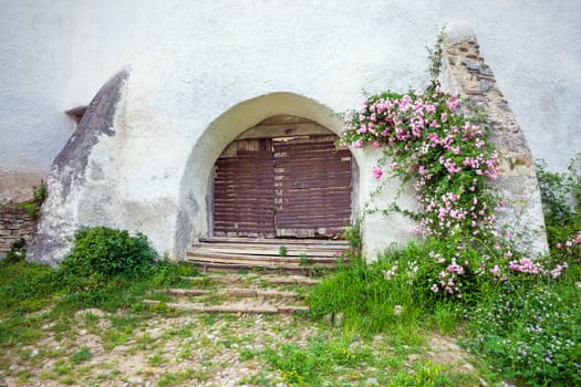 Viscri, Romania - June 23, 2013: Fortified Church at Viscri in TransylvaniaFortified Church entrace gate at Viscri in Transylvania, Romania