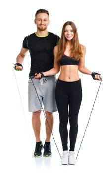 Happy athletic couple - man and woman with with ropes on the white background