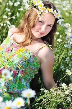 beauty spring teen girl with garland from daisies