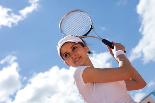 Woman playing tennis in summer
