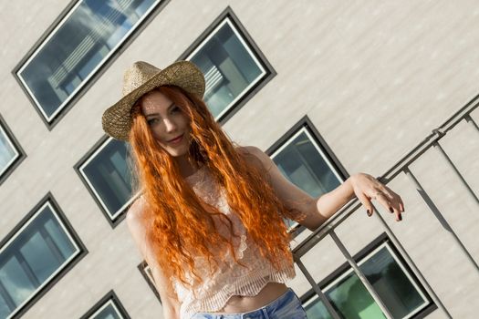 Close up Gorgeous Blond Woman Wearing Hat, Looking at Camera, on Cloudy Sky background