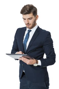 Businessman using a tablet computer navigating the touchscreen with his finger as he surfs the internet, close up view of his hands and the tablet, on white