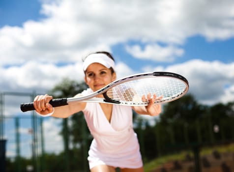 Young woman tennis player on the court