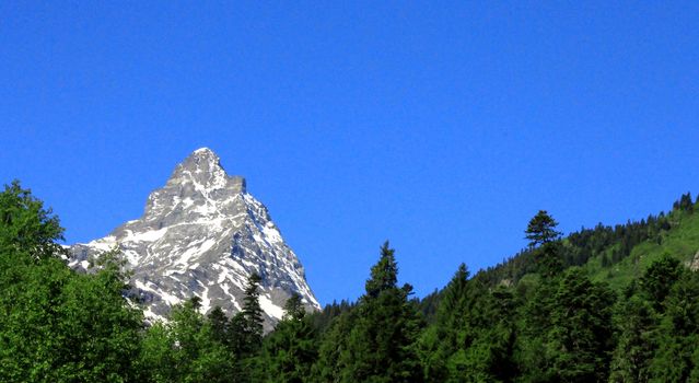 Caucasus Mountains Under Snow And Clear Blue Sky