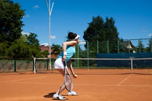 Young woman playing tennis, summertime saturated theme