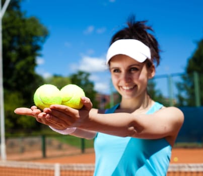 Young woman playing tennis, summertime saturated theme