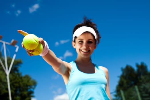 Young woman playing tennis, summertime saturated theme