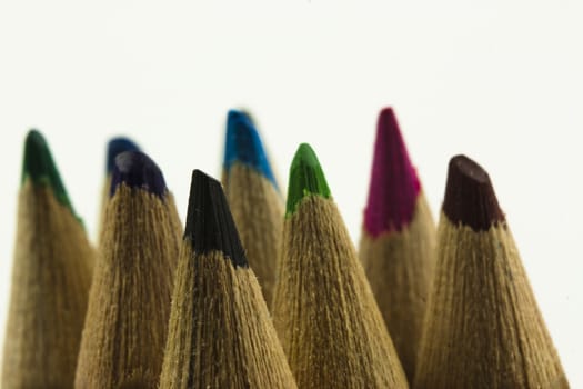 Close f of coloured pencils against a wooden background