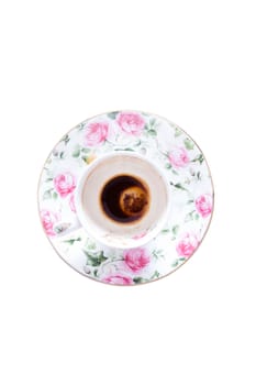Finished cup of Turkish in a dainty pretty floral porcelain cup and saucer decorated with pink roses coffee viewed from above isolated on white