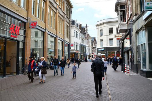 The Hague, Netherlands - May 8, 2015: People shopping on venestraat shopping street in The Hague, Netherlands. on  May 8, 2015. The Hague is the capital city of the province of South Netherlands. With a population of 515,880 inhabitants.