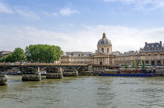 Institut de France and the Pont des Arts or Passerelle des Arts bridge across river Seine in Paris, France.