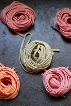 colorful pasta tagliatelle on a wooden table
