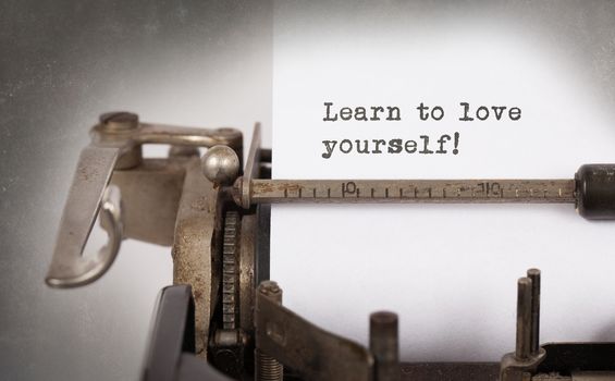 Vintage inscription made by old typewriter, Learn to love yourself