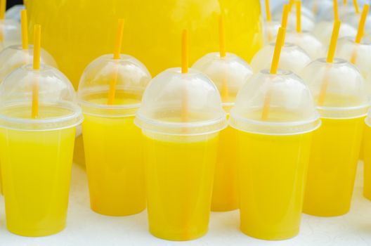 Yellow lemonade plastic cups with tubes and flares