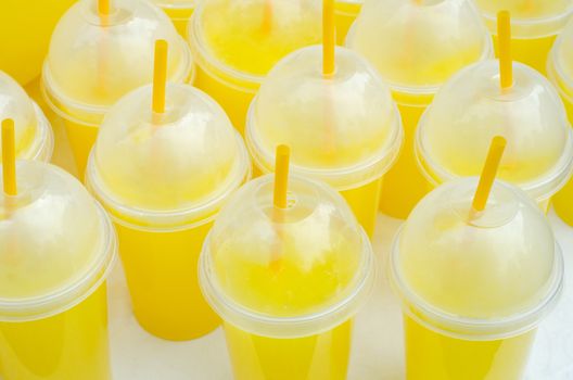 Yellow lemonade plastic cups with tubes and flares