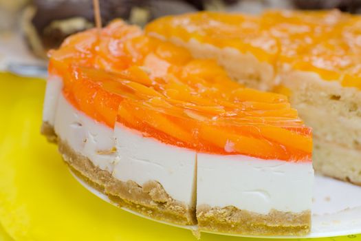 Jelly orange and white cake cut into triangles