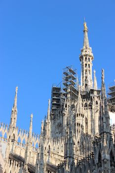 Spires, pinnacles, and statues, with decorated flying buttresses...