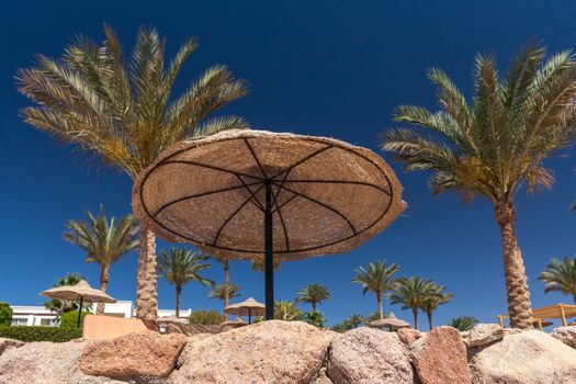 The beach at the luxury hotel, Sharm el Sheikh, Egypt. umbrella against the blue sky