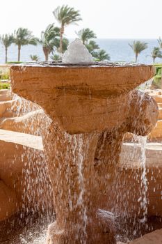 The beach at the luxury hotel, Sharm el Sheikh, Egypt. fountain in the foreground. water splashing