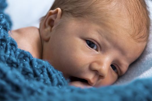 Close up Cute White New Born Baby Lying in Prone on White Cotton Cloth with Open Mouth