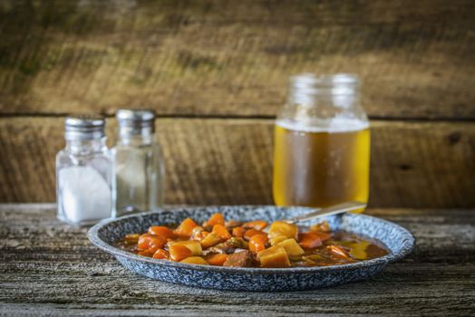 Plate of hearty beef stew on a rustic background.