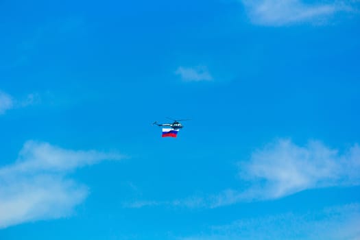 Photo of flying helicopter in blue sky