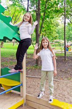 Photo of two playing girls in summer