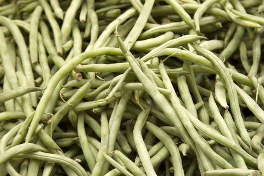 Fresh juicy green beans on a counter in the market of India of Goa.