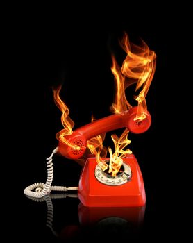 Hot line phone in fire flames black backround