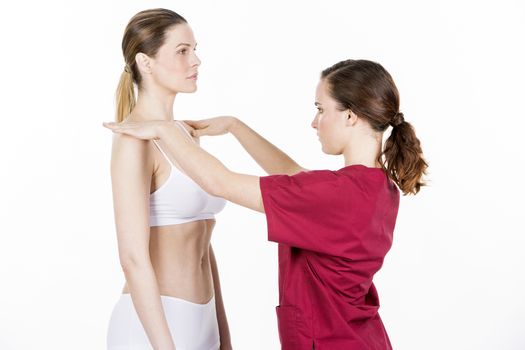 physiotherapist doing a physical examination of a woman