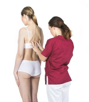 physiotherapist doing a physical examination of a woman