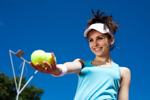 Young woman playing tennis, summertime saturated theme