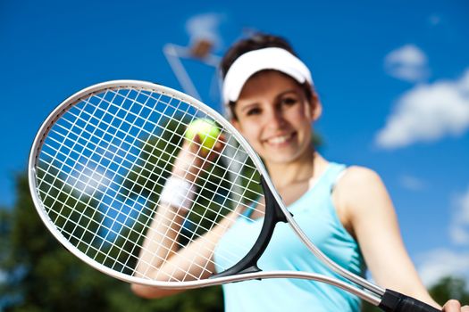 Woman playing tennis, summertime saturated theme